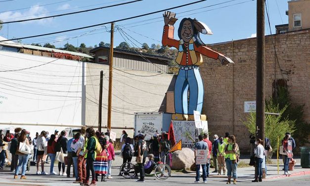 Marchers rally against ‘the chief’ sign
